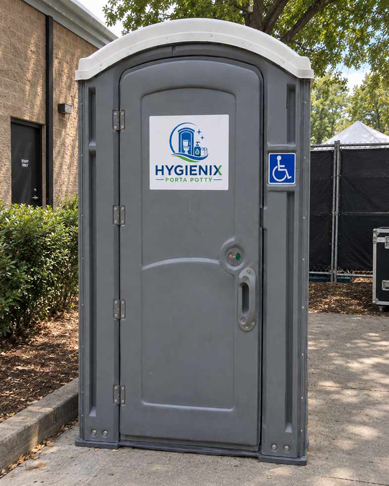 Grey Hygienix Porta Potty ADA unit with wheelchair sign by brick building