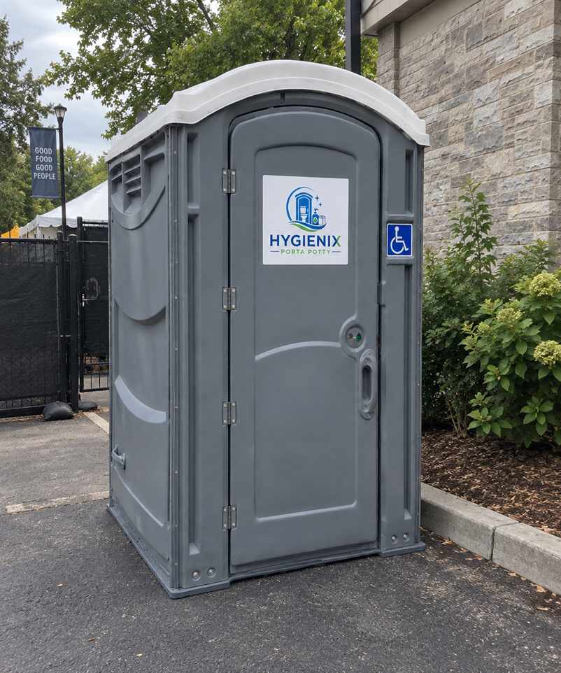 Hygienix Porta Potty ADA unit on sidewalk beside building wall