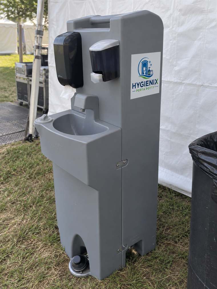 Hygienix Porta Potty handwash station beside white event tent