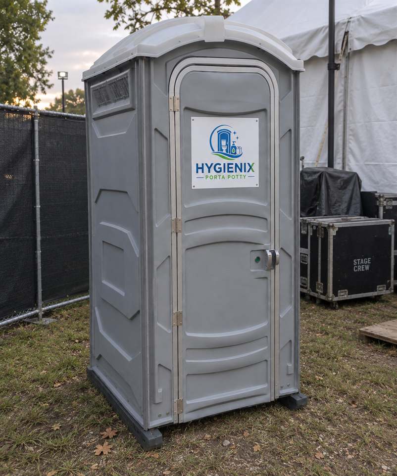 Grey Hygienix Porta Potty standard unit behind event fencing