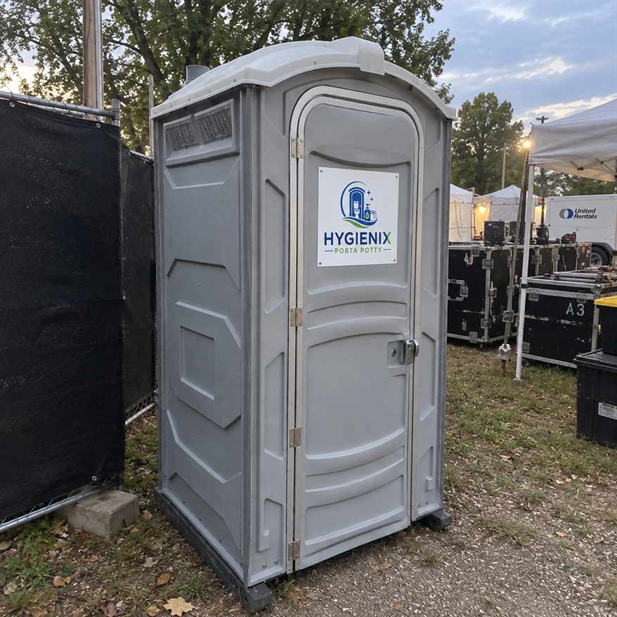 Grey Hygienix Porta Potty standard unit at dusk festival