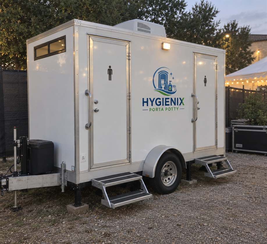 White Hygienix Porta Potty restroom trailer with string lights